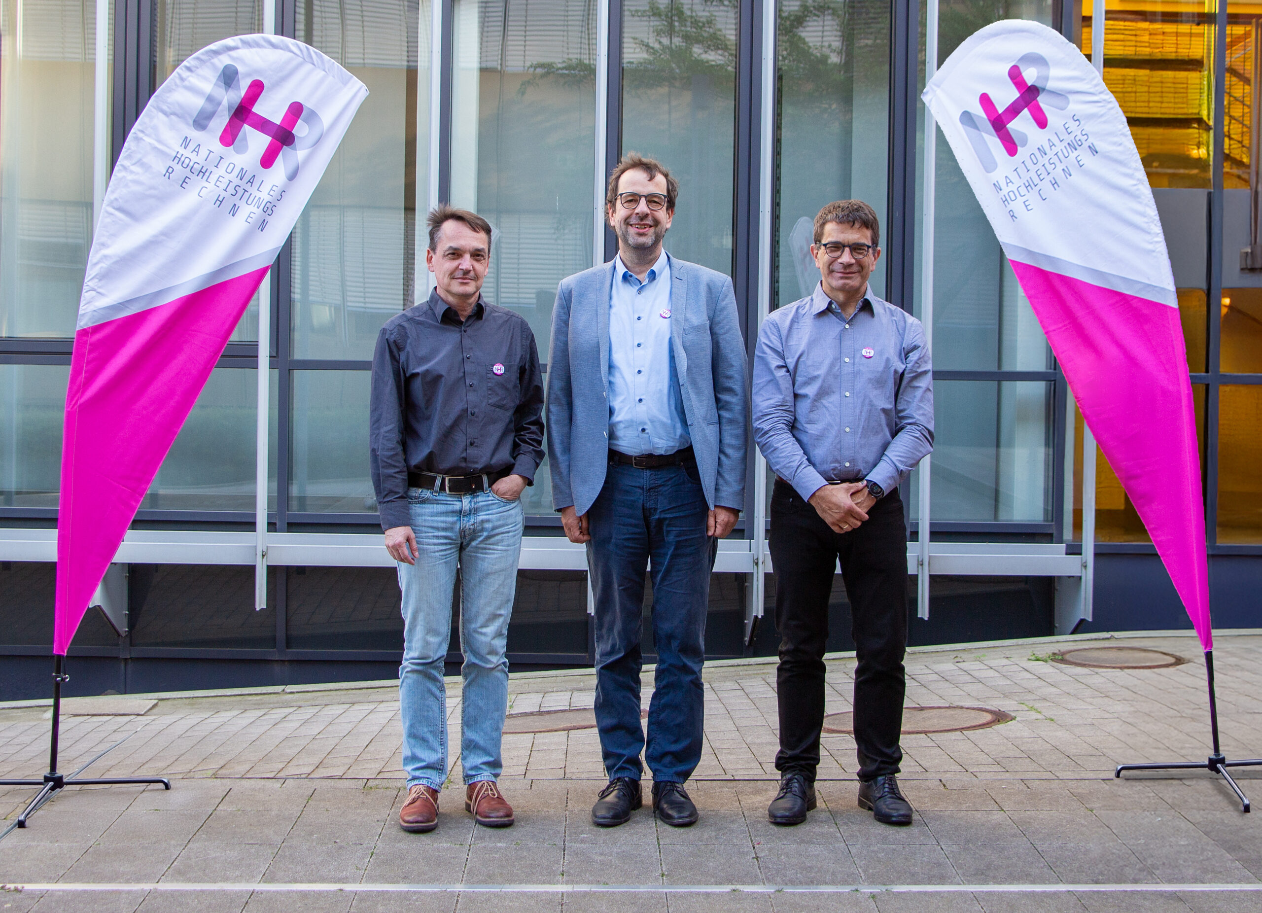 The board of directors of the NHR Alliance - three men in front of a building